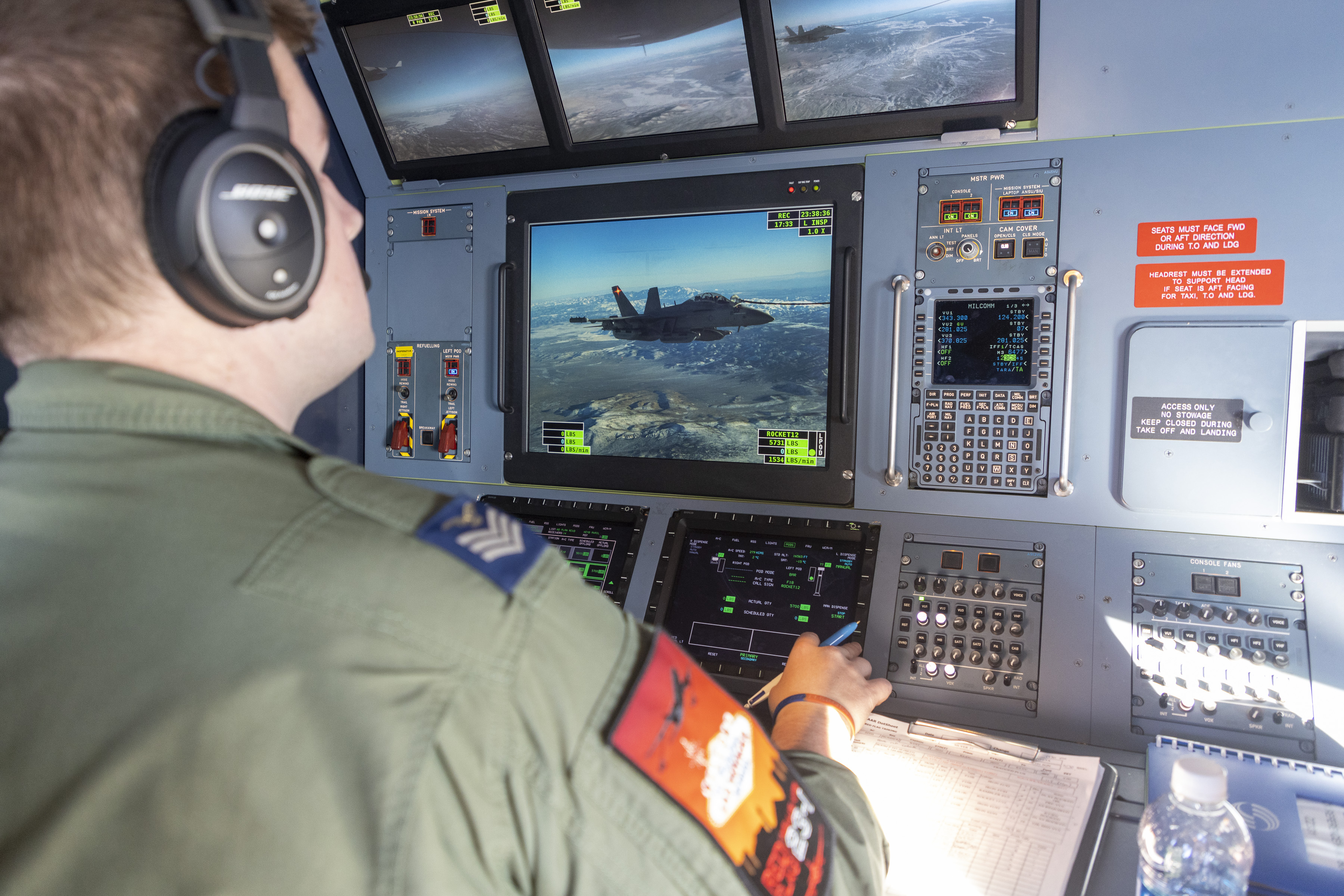 Image shows RAF aviator using monitor to refuel aircraft in flight.